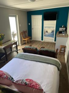 a bedroom with a bed and a view of the beach at Grace from Above in Malmesbury