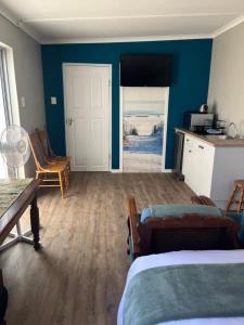 a bedroom with a bed and a view of the beach at Grace from Above in Malmesbury