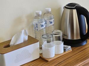 a counter with two bottles of water and a blender at Chortip House in Pai