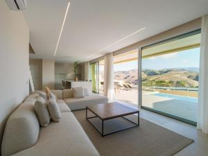 a living room with a couch and a table at Salobre Golf Villas Kaiman in Salobre