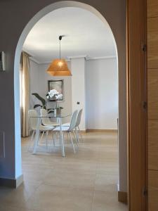 a dining room with a table and chairs at SunGolf Apartment in Los Alcázares