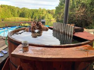 two people in a hot tub in a pool at Rio Maullin Lodge in Puerto Varas