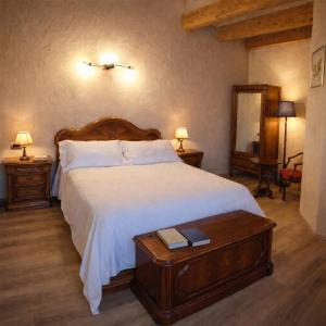 a bedroom with a large bed with a wooden headboard at Monforte Country House in Monforte dʼAlba +33 photos