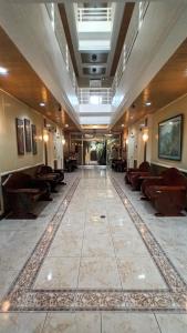 a lobby with couches and chairs in a building at Paper Country Inn in Mangagoy