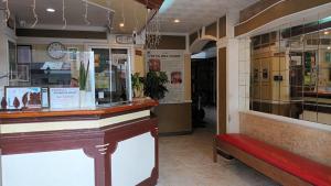 a restaurant with a counter and a red bench at Paper Country Inn in Mangagoy