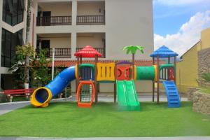 a playground in front of a building at USCEESP Praia Grande in Praia Grande