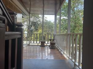 a screened porch with a view of the woods at Paljor Farm in Ravangla