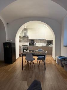 a kitchen with a table and chairs in a room at Elle's House in Savona
