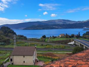 a building with a view of a lake and mountains at Ultreia in Arcade