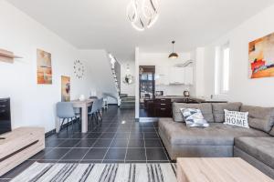 a living room with a couch and a table at Coastal Haven Talea by PikHost in Tale