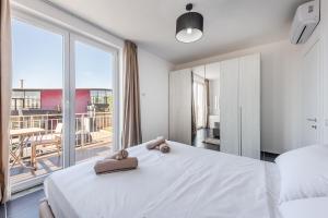 a bedroom with a white bed and a balcony at Coastal Haven Talea by PikHost in Tale +76 photos