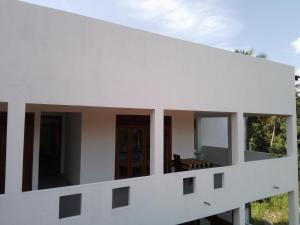 a view of a white building with windows at Wijaya Garden Hotel in Anuradhapura