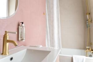 a bathroom with a white sink and a mirror at Hotel Boileau in Paris