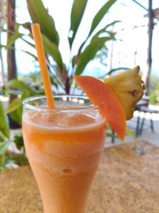 a glass of orange juice with an orange slice at Laeley 1,000 miles resort in Ko Lanta Yai