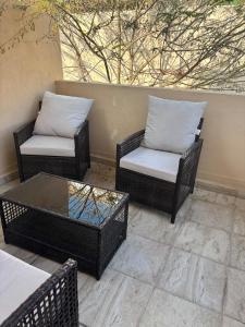 three wicker chairs and a coffee table on a patio at Hermosa casa familiar con terraza comoda in Xochitepec