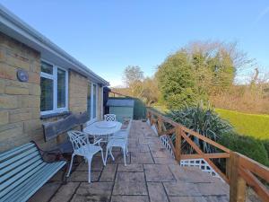 a patio with chairs and a table and a bench at 2 Bed in Brighstone oc-n30464 in Brighstone