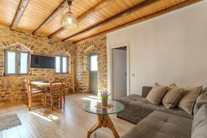 a living room with a couch and a table at Stone house koumani in Thalámai