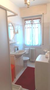 a white bathroom with a sink and a toilet at CASA AZZURRA Domodossola FREE PARKING in Domodossola