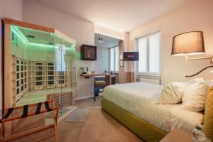 a hotel room with a bed and a glass window at Boutique Casa Giulietta in Como