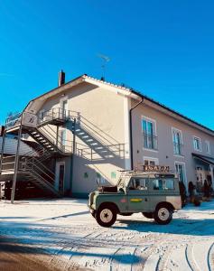 a green jeep parked in front of a building at Brandmayerhof in Oberding