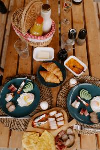 a table with plates of breakfast foods on it at TogetherNest - Cedar in Mătişeşti +29 photos
