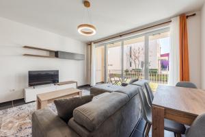 a living room with a couch and a table at Blue Haven Talea by PikHost in Tale