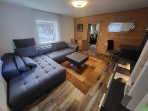 a living room with a couch and a table at Ferienwohnung-Gerti in Uderns