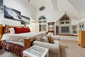 a bedroom with a bed and a couch and windows at The Rest in Jackson