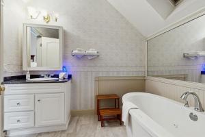 a white bathroom with a tub and a sink at The Rest in Jackson +43 photos