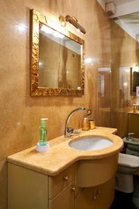 a bathroom with a sink and a mirror at P&P Piazza Bergamo Apartment in Bergamo +60 photos