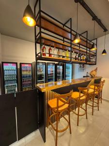 a bar with wooden tables and chairs in a restaurant at Ibirama Vale Hotel in Ibirama