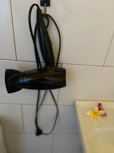a black purse hanging on the wall of a bathroom at Studio Sunset Rapa Nui in Hanga Roa