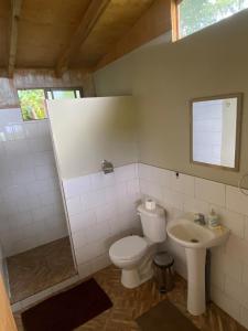 a bathroom with a toilet and a sink at Studio Sunset Rapa Nui in Hanga Roa +27 photos
