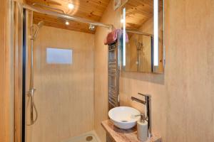 a bathroom with a sink and a shower at Finest Retreats - Demelza Shepherds Hut in Grade