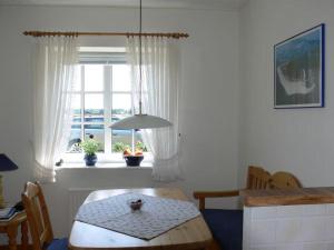 a dining room with a table and a window at Viktor-Jaeger-Stiftung in Nebel
