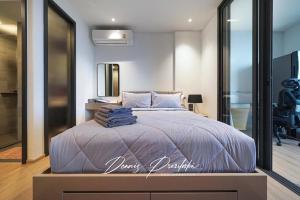 a bedroom with a large bed with towels on it at Luxury Edge Seaview Apartment in Pattaya South