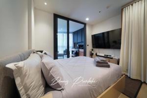 a bedroom with a large bed and a large window at Luxury Edge Seaview Apartment in Pattaya South