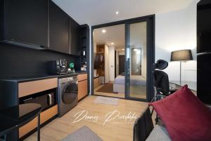 a living room with a kitchen and a bedroom at Luxury Edge Seaview Apartment in Pattaya South +49 photos