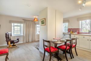 a kitchen and dining room with a table and chairs at 2 Bed in Bressingham oc-f33646 in Bressingham