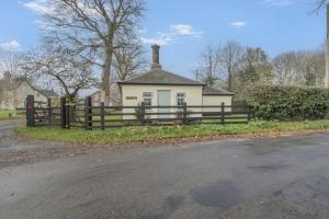 a house with a fence in front of it at 2 Bed in Bressingham oc-f33646 in Bressingham