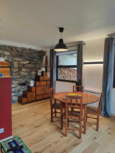 a dining room with a wooden table and chairs at Ailleurs La Chalp à Saint-Véran in Saint-Véran +7 photos