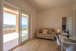 a living room with a view of the ocean at Villa Adele con piscina privata vicino Tropea - per 16 persone in Torre Marino