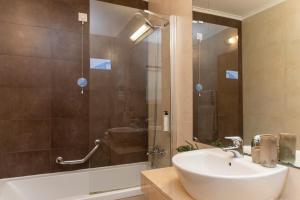 a bathroom with a sink and a shower at WOT Ericeira in Ericeira +42 photos