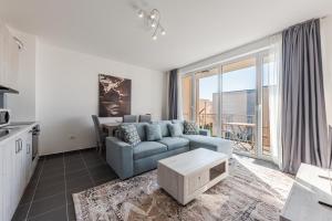 a living room with a couch and a table at Serene Haven Talea by PikHost in Tale