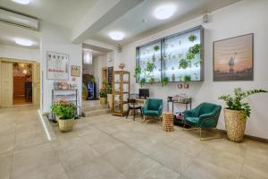 a lobby with chairs and a table in a building at Salvator Boutique Hotel vegan-friendly in Prague