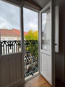 an open door with a view of a balcony at Casa Clara in Castelo de Vide