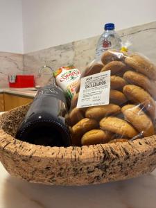 a basket of bagels and a bottle of water at Casa Clara in Castelo de Vide