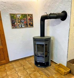 a stove in the corner of a room at Movika in Neef