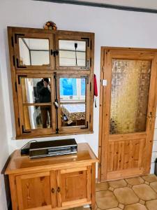 a room with a wooden cabinet and a door at Movika in Neef +7 photos
