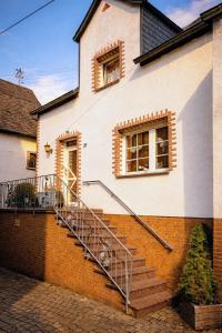 a house with a staircase in front of a building at Movika in Neef
